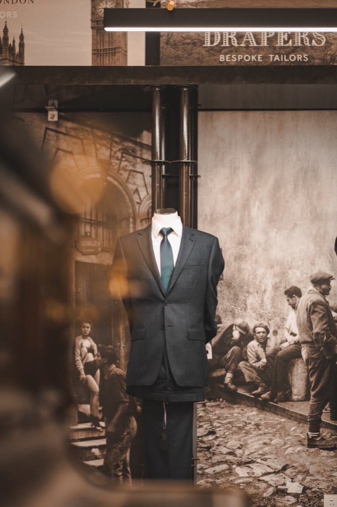 Bespoke suiting on display with heritage tailoring mural at Joseph Uzumcu Adelaide